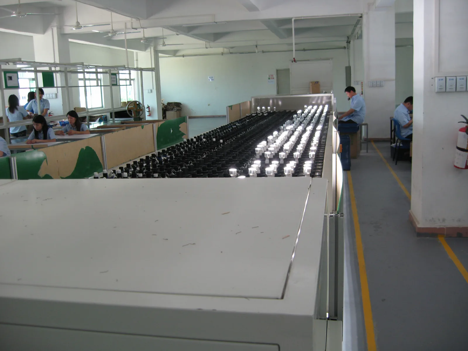 LED lighting ageing line with fixtures operating during a factory process